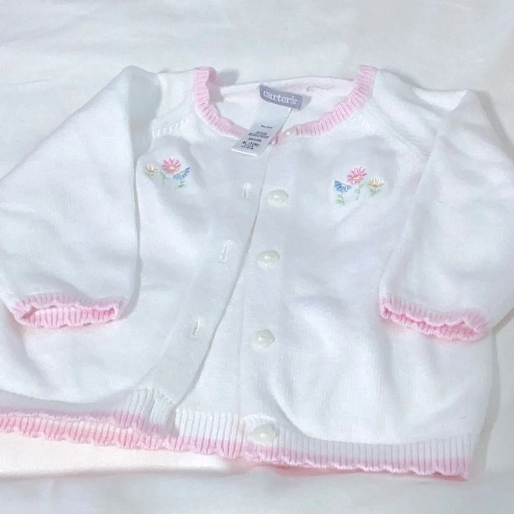 Carter’s white sweater with pink trim on neck, sleeve and hem. 12 months